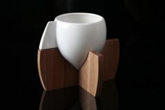 A coffee cup with a conical base. A coffee cup with a strange shape.