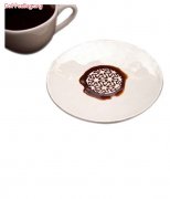 The coffee cup and saucer with embossed texture looks more beautiful when it overflows.