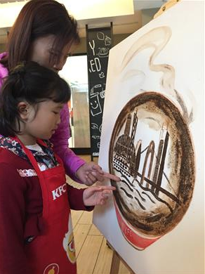 The humble coffee grounds outline the landmarks of Guangzhou